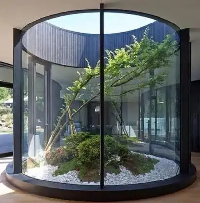 Round glass habitat with a tree inside of it